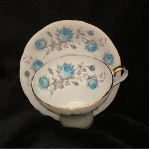 Vintage English bone china teacup and saucer with blue roses designed by Aynsley